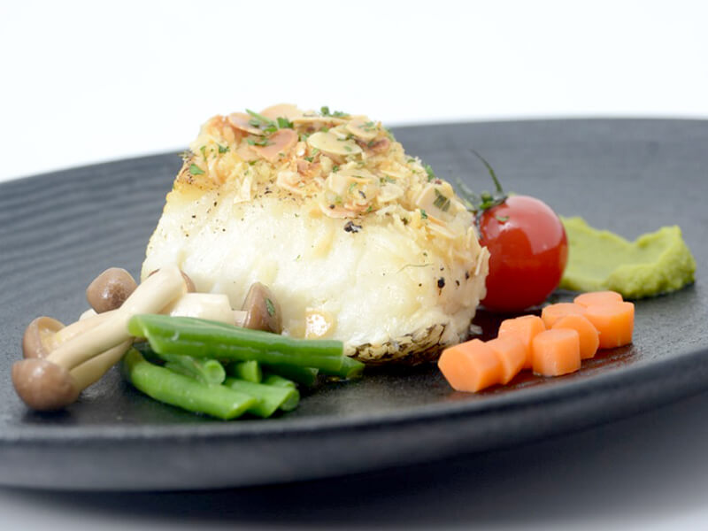 almond crusted Chilean sea bass with edamame purée & carrot basil sauce